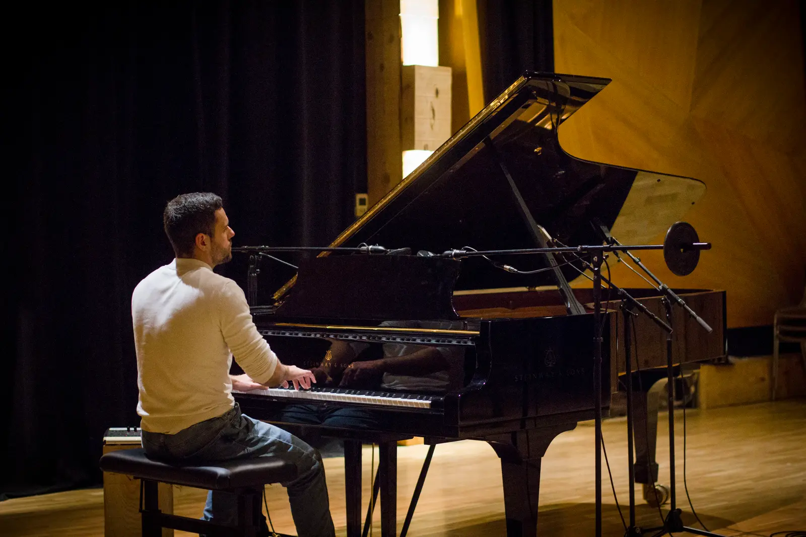 David Catá at the grand piano on the studio stage